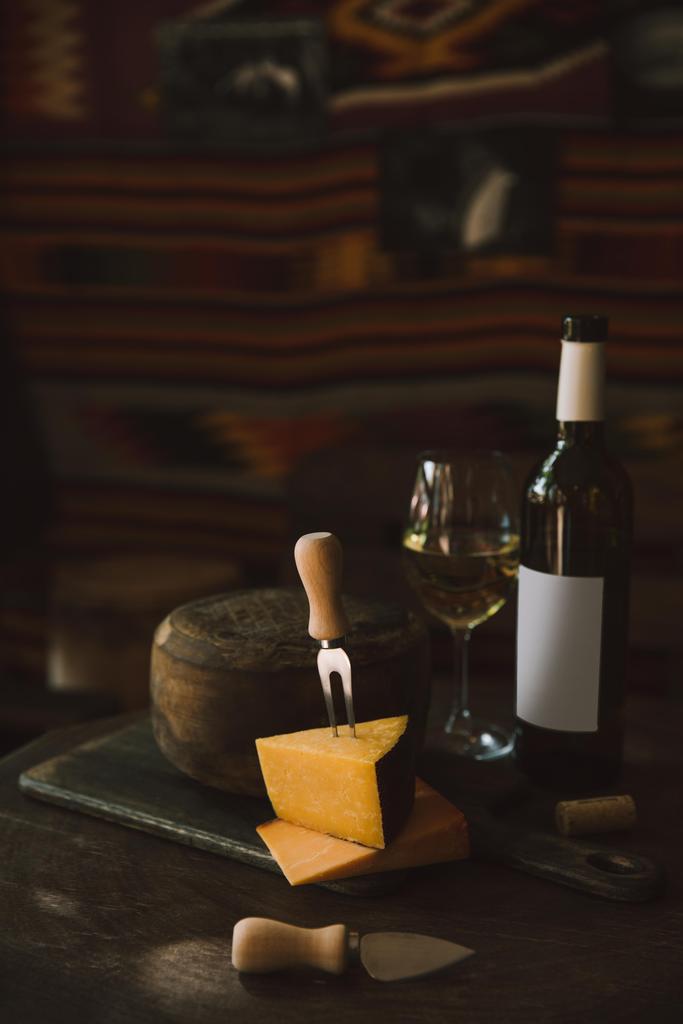 sliced cheese with white wine on rustic wooden table - Photo, Image