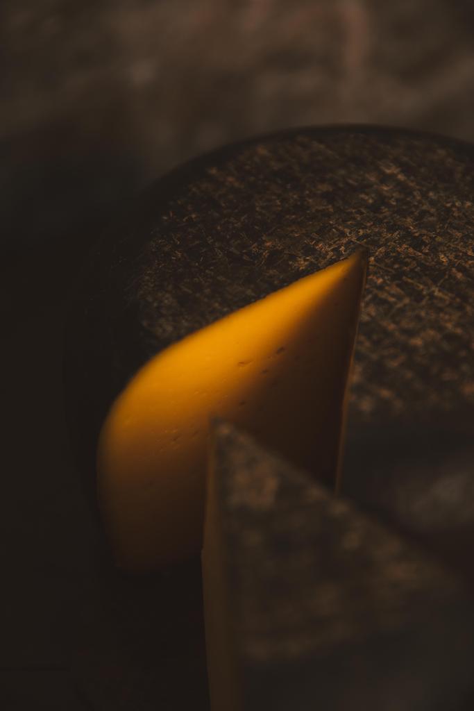 close-up shot of sliced cheese on rustic wooden cutting board - Photo, Image