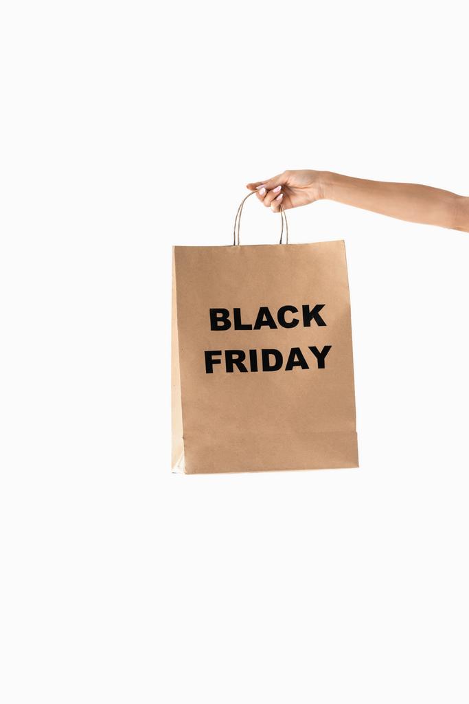 vista parcial de la mano con bolsa de compras para viernes negro, aislado en blanco
 - Foto, Imagen