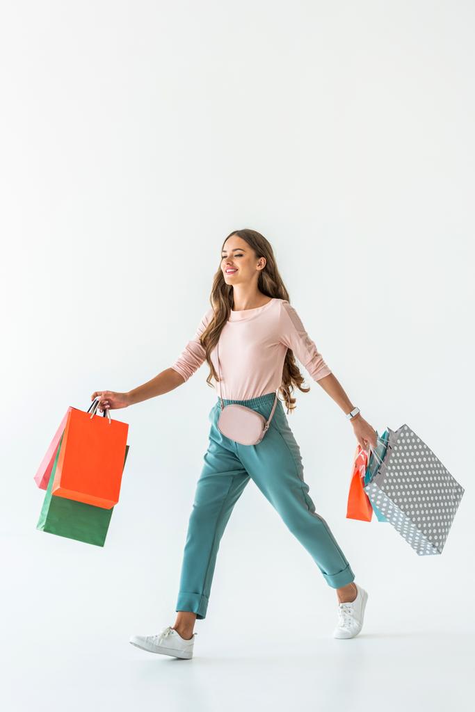 beautiful happy woman walking with shopping bags, isolated on white - Photo, Image