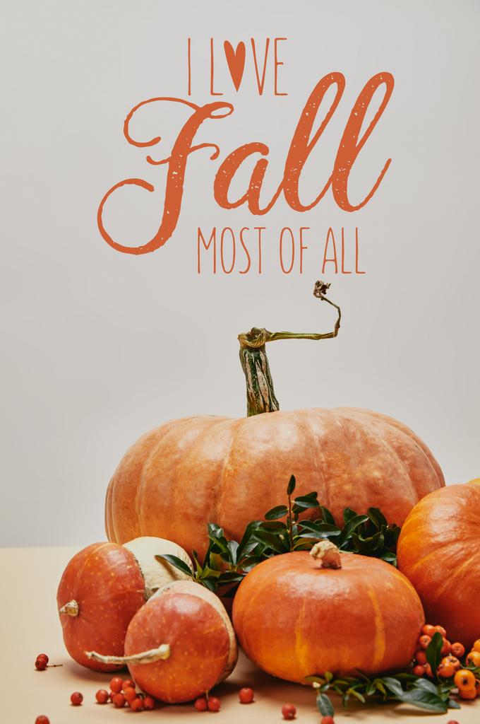beautiful autumnal decoration with pumpkins and firethorn berries on table with I LOVE FALL MOST OF ALL lettering - Photo, Image