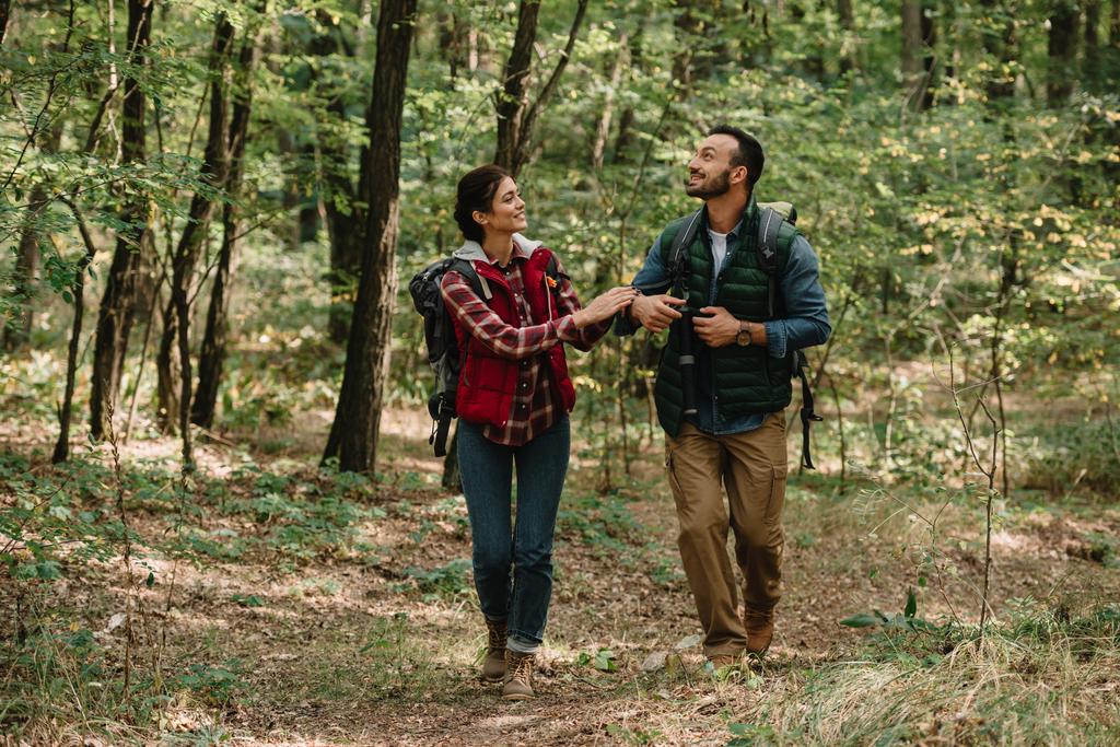 couple of travelers with backpacks hiking in forest - Photo, Image