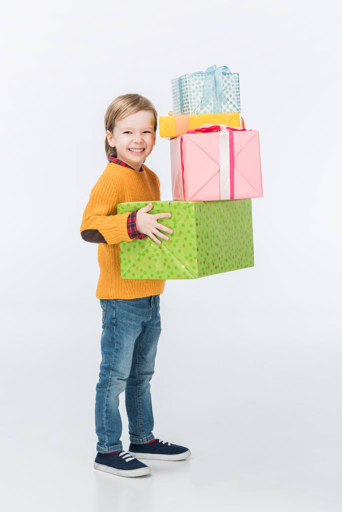 smiling boy with wrapped gifts isolated on white  - Photo, Image