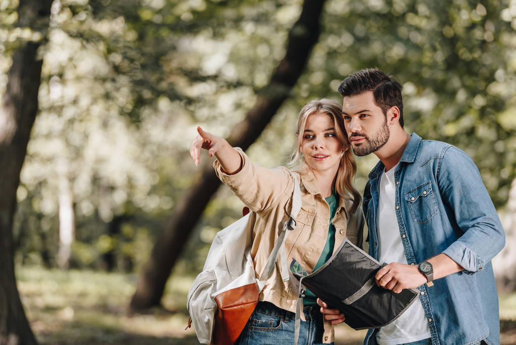 portrait of couple of tourists with map in park - Photo, Image