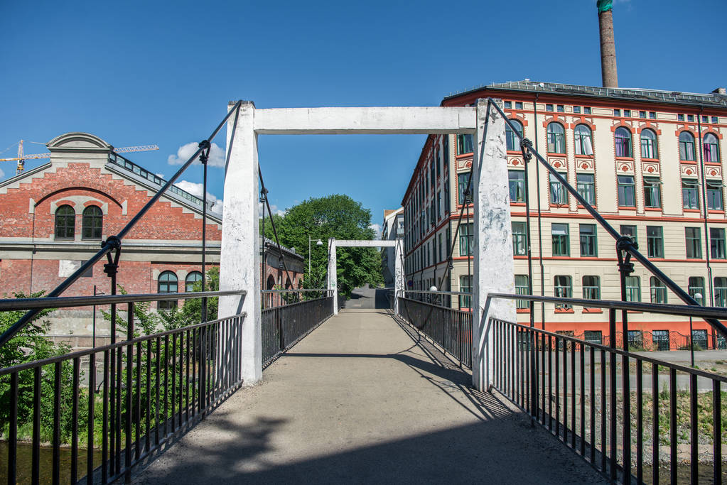 empty bridge across river and beautiful old buildings at sunny day, oslo, norway - Photo, Image