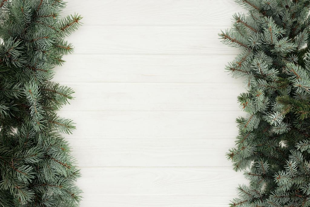 вид зверху красиві вічнозелені гілки ялинки на білому дерев'яному фоні
      - Фото, зображення