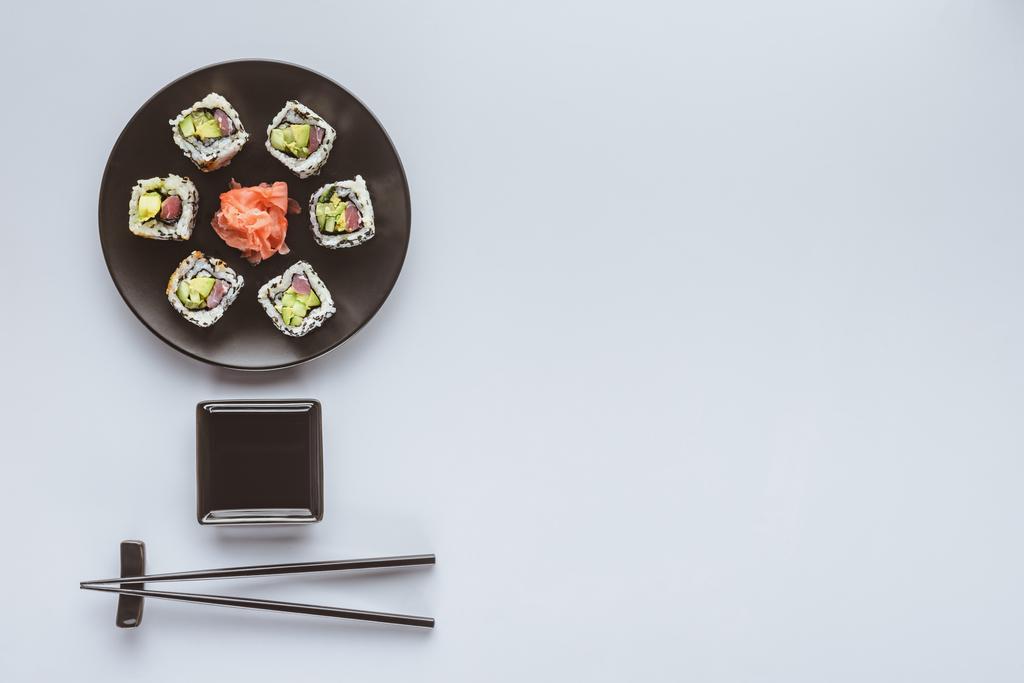 top view of delicious sushi with ginger and chopsticks isolated on white  - Photo, Image