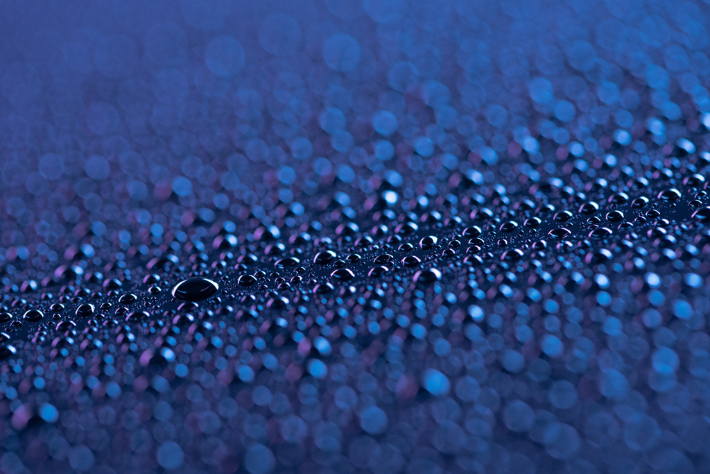 selective focus of water drops on blue surface as background - Photo, Image