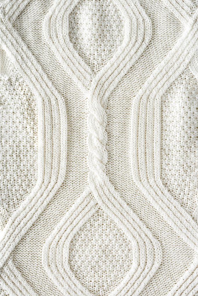plein cadre de tissu tricoté blanc avec motif comme fond
 - Photo, image