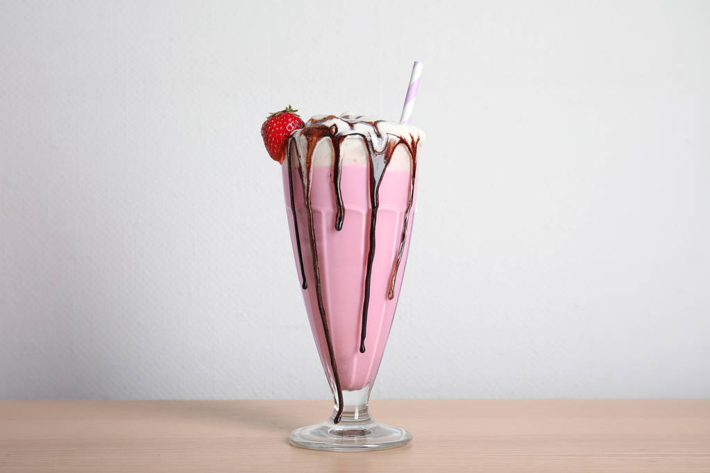 Glass of tasty milk shake on table - Photo, Image