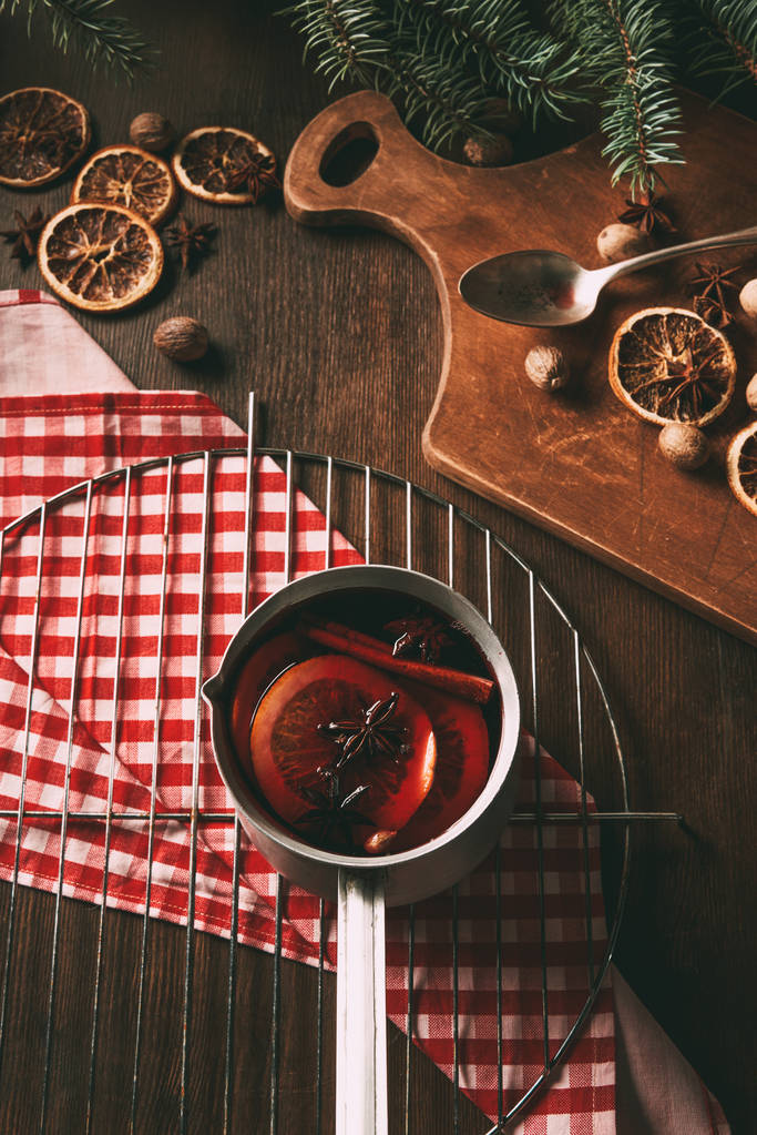homemade hot mulled wine in saucepan with spices on wooden background - Photo, Image