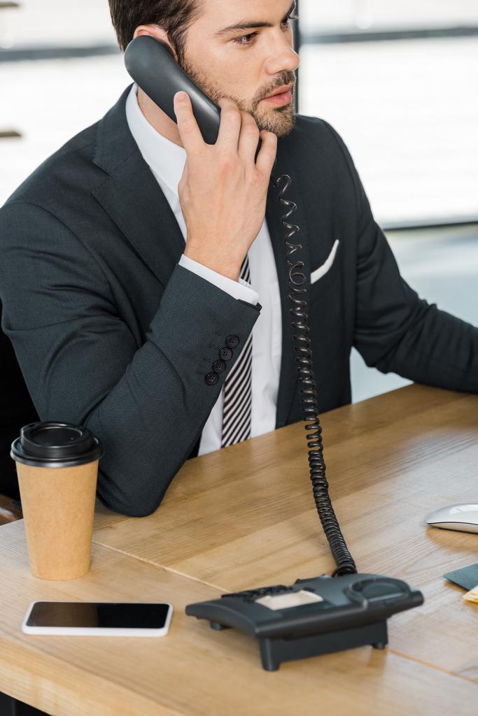 guapo hombre de negocios hablando por teléfono fijo en la oficina
 - Foto, Imagen