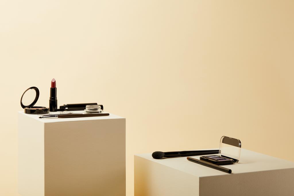 various makeup supplies on beige cubes - Photo, Image