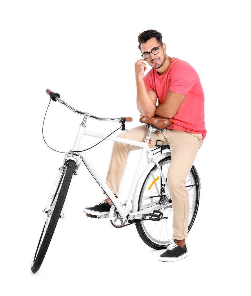 Handsome young hipster man with bicycle on white background - Photo, Image