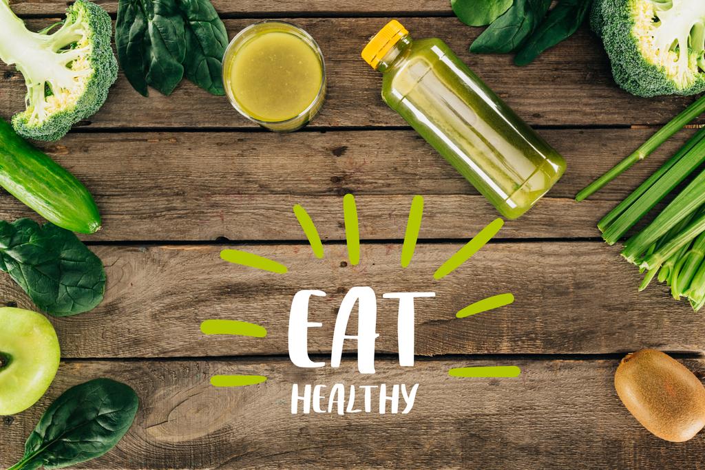 flat lay with detox drink and various organic food on wooden surface with "eat healthy" lettering - Photo, Image