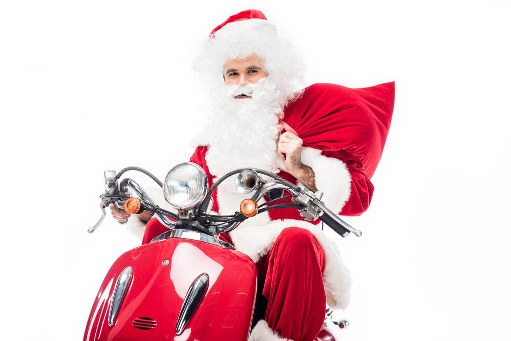 Joulupukki puku tilalla joulun säkki ja ratsastus skootteri eristetty valkoisella taustalla
  - Valokuva, kuva