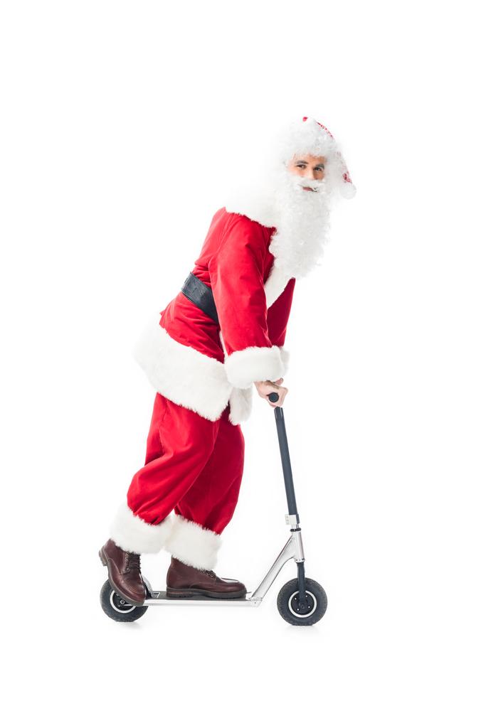 happy santa claus in costume riding on kick scooter isolated on white background - Photo, Image