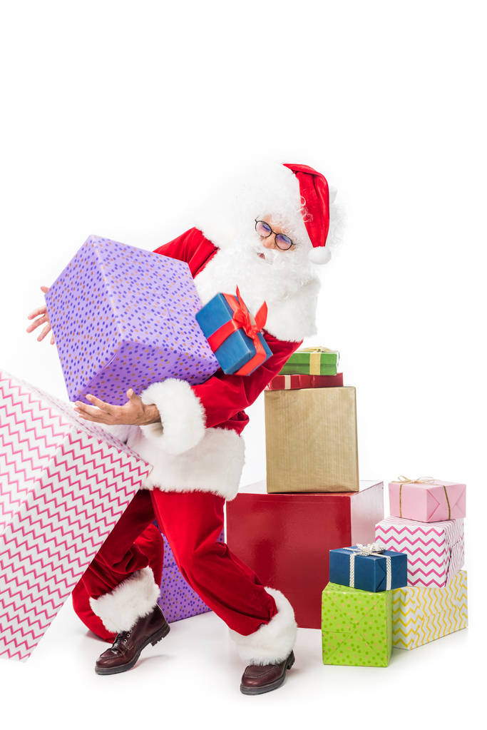 Papai Noel em óculos caindo pilha de caixas de presente isolado em fundo branco
  - Foto, Imagem