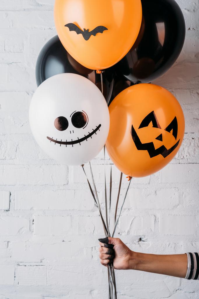 cropped shot of woman holding various halloween balloons - Photo, Image