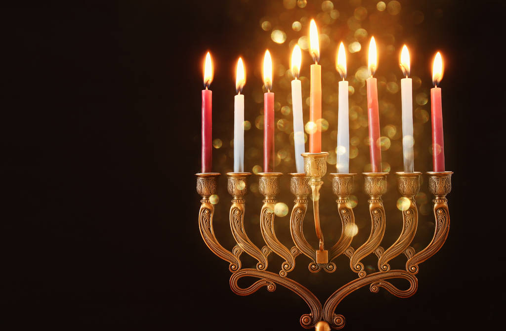 Low key Image of jewish holiday Hanukkah background with menorah (traditional candelabra) and burning candles - Photo, Image