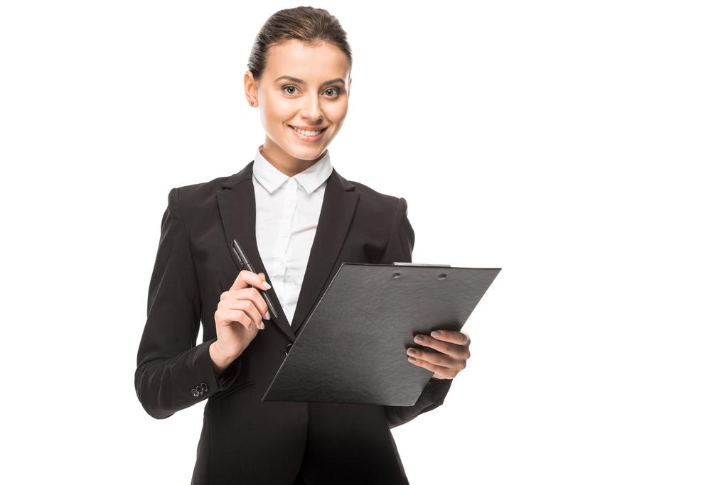 smiling young businesswoman in suit with clipboard looking at camera isolated on white - Photo, Image