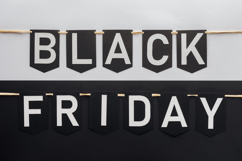 black friday lettering on flag garlands on black and white background - Photo, Image