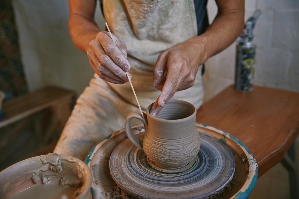 cropped image of man decorating clay pot at workshop - Photo, Image