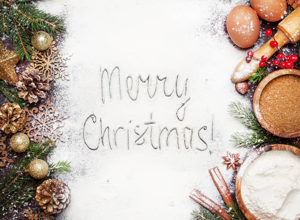 Рождественская или новогодняя композиция с ингредиентами для выпечки или с золотыми снежинками, рождественские шары, зеленые елки, сосновые шишки, на белом фоне муки, рама, вид сверху
 - Фото, изображение