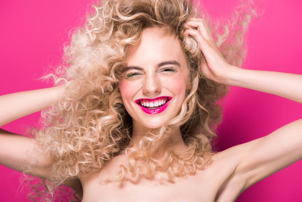 attractive naked girl with long curly hair laughing isolated on pink  - Photo, Image