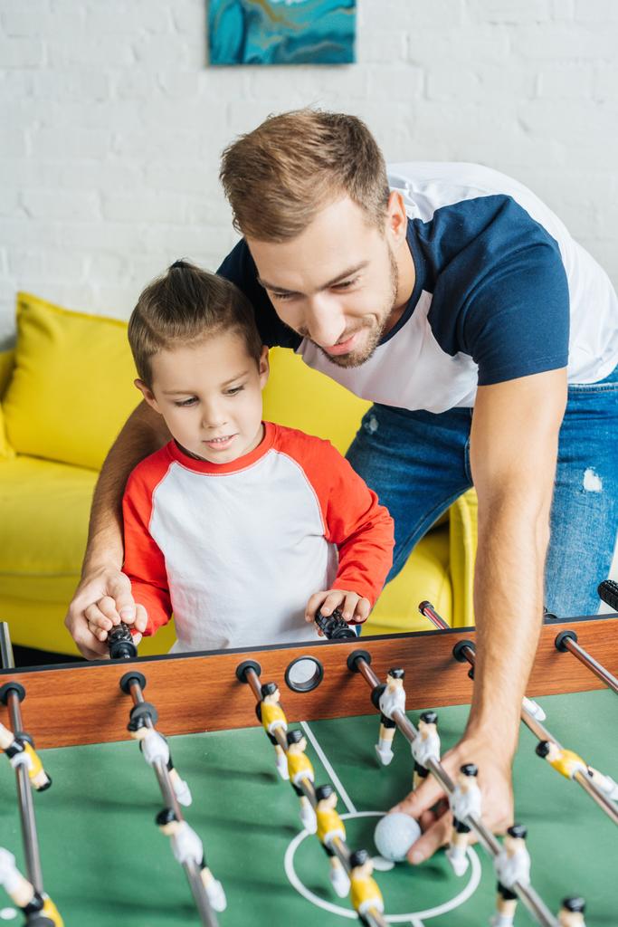 father and son playing table football together at home - Photo, Image