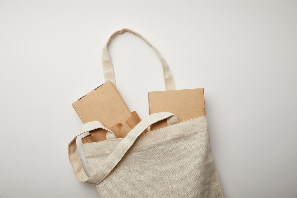 flat lay com saco de algodão com caixas de alimentos e pauzinhos na superfície branca
 - Foto, Imagem