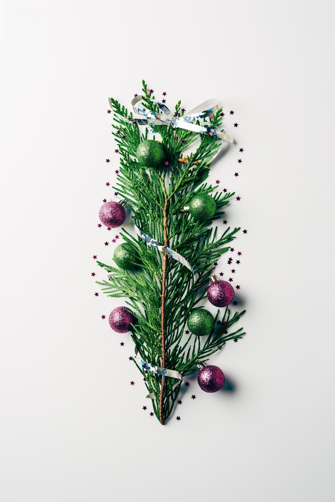 top view of green pine branch decorated with christmas toys as christmas tree on white backdrop - Photo, Image