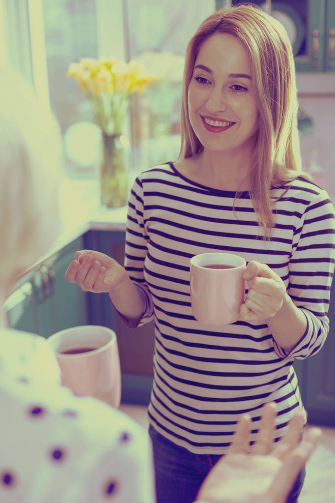 Positive delighted female person having pleasant talk - Photo, Image