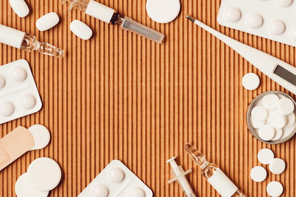 вид различных медицинских инструментов и препаратов на фоне картона
 - Фото, изображение