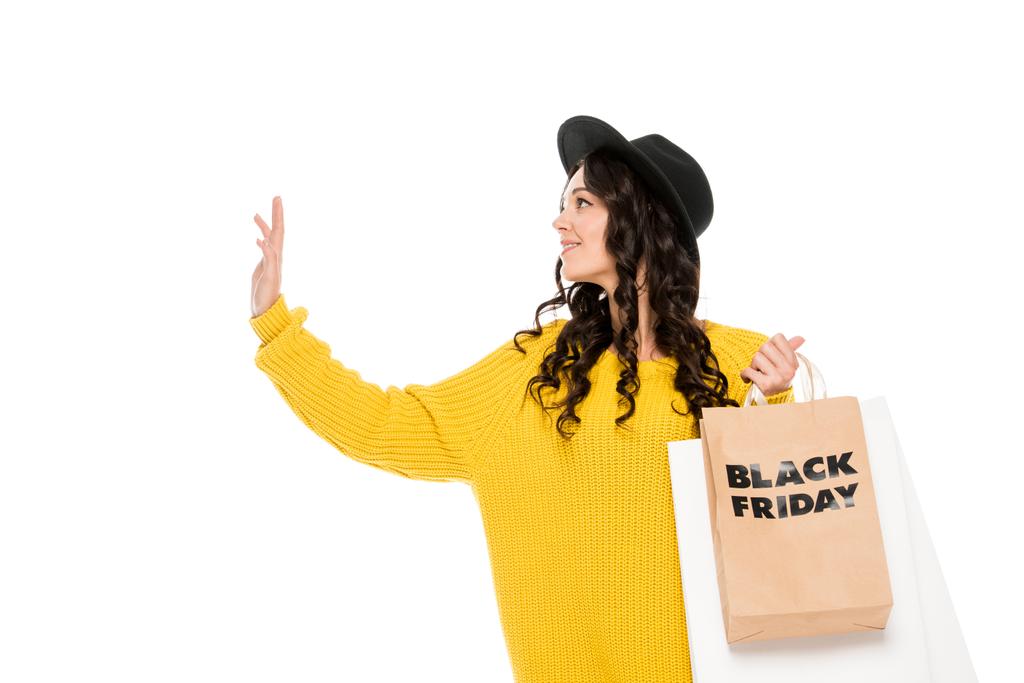 bonito elegante shopaholic gestos e segurando sacos de compras com símbolos sexta-feira preto, isolado no branco
 - Foto, Imagem