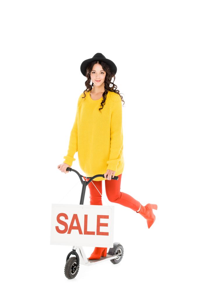 beautiful stylish girl riding scooter with sale sign isolated on white - Photo, Image