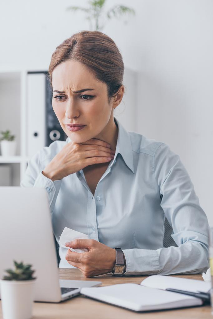 страдает больная деловая женщина с больным горлом пытается работать в офисе
 - Фото, изображение