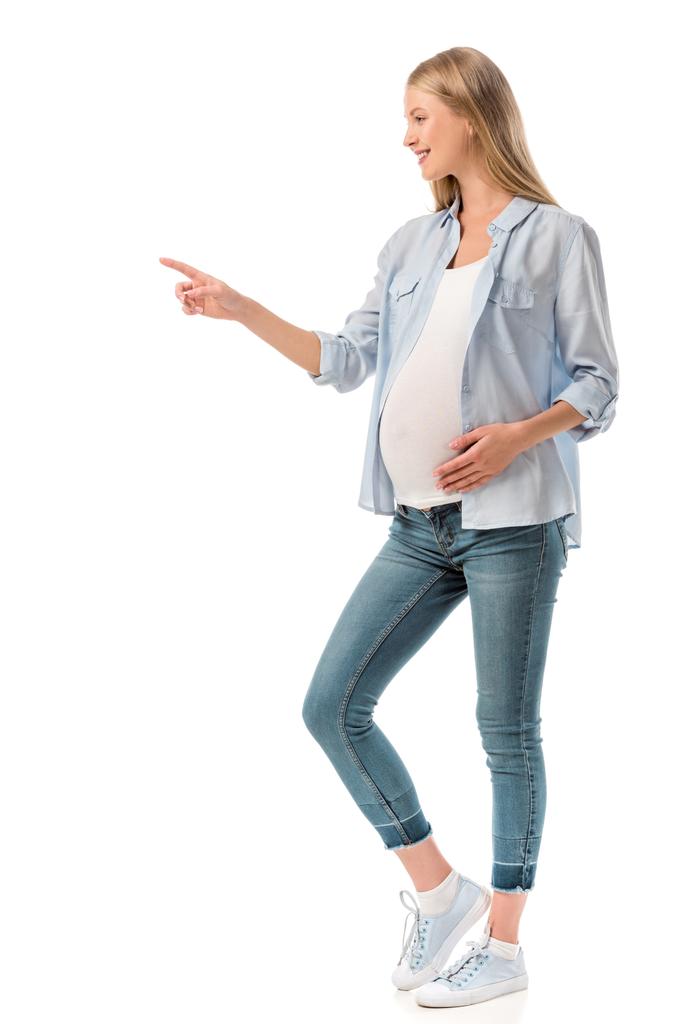 вид збоку вагітної жінки, що вказує на порожній простір ізольовано на білому
 - Фото, зображення