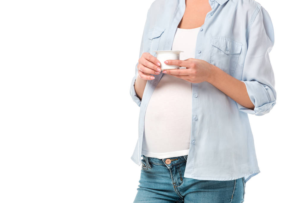 cropped shot of pregnant woman holding yogurt isolated on white - Photo, Image