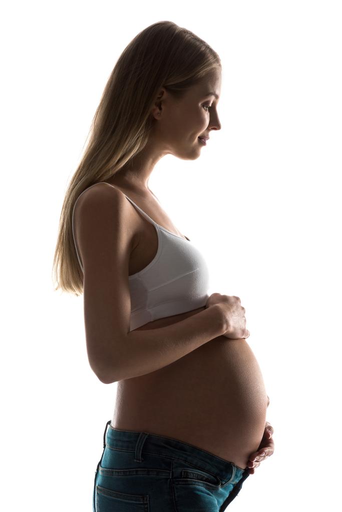 Karnı üzerinde beyaz izole dokunmadan hamile kadın silüeti - Fotoğraf, Görsel