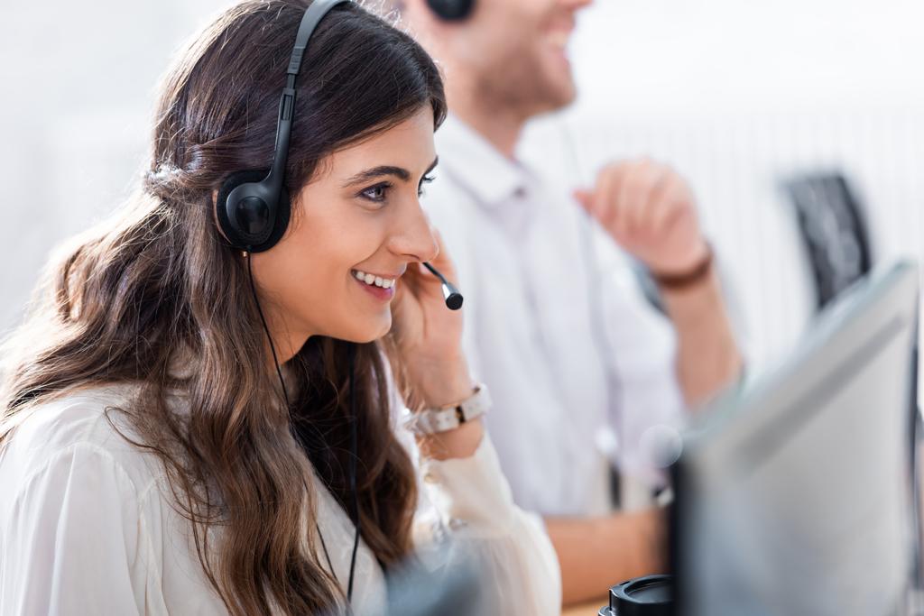 selective focus of smiling female call center operator in office - Photo, Image