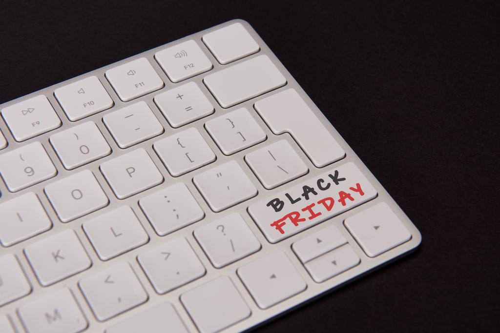 close-up shot of computer keyboard with black friday button isolated on black - Photo, Image