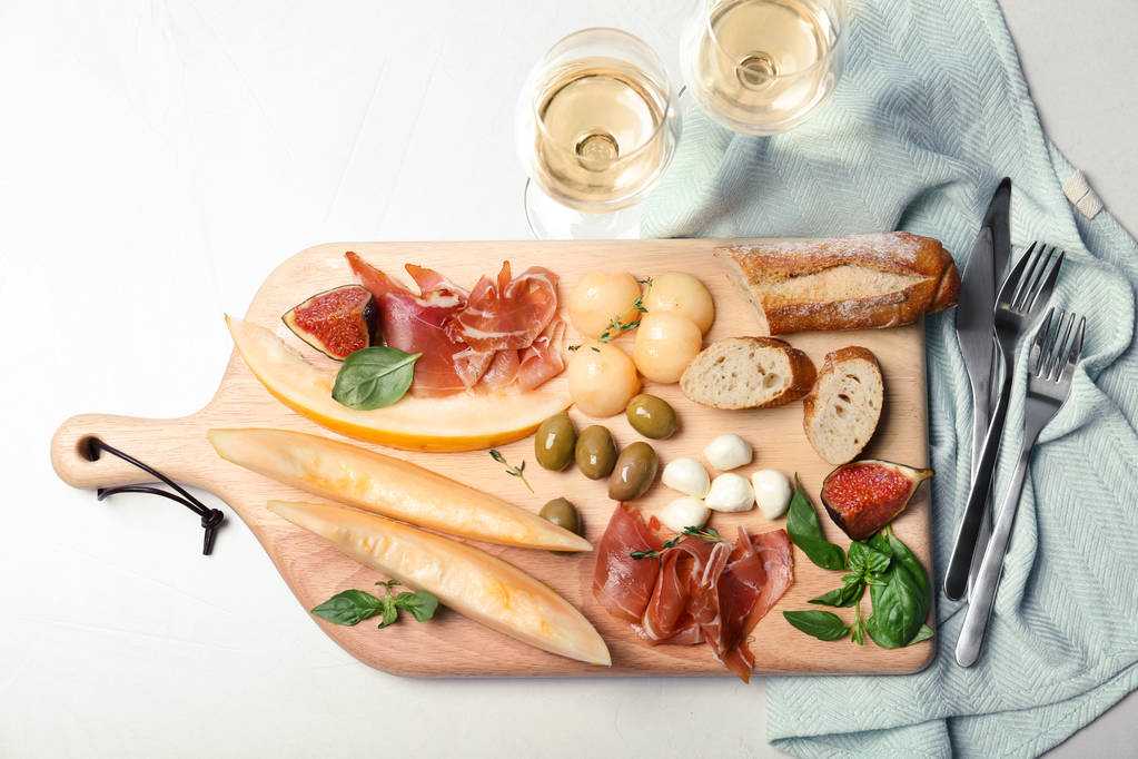Flat lay composition with melon and prosciutto appetizer on table - Photo, Image