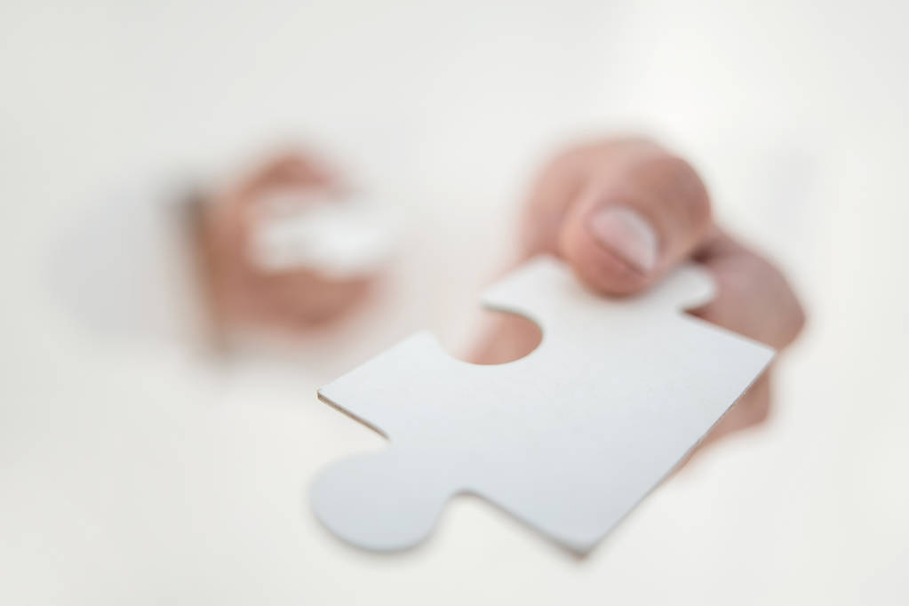 close up.the image of a piece of the puzzle in the hands of a bu - Photo, Image