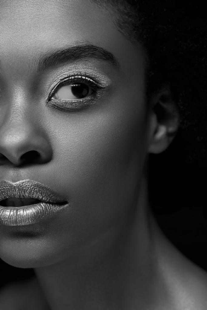 foto en blanco y negro de una mujer afroamericana mirando hacia otro lado aislada en negro
 - Foto, Imagen