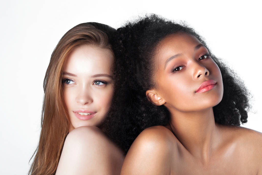 Caucasian and african teen girls close-up. Skin care and makeup. Mixed race beauty portrait - Photo, Image