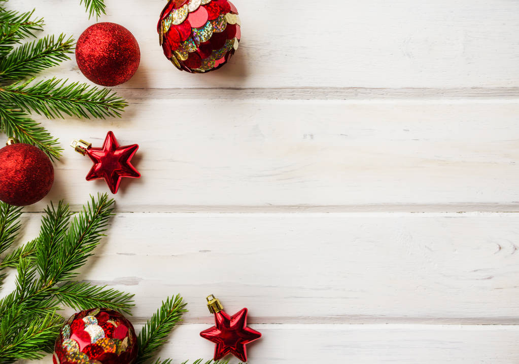 Sullo sfondo natalizio con decorazioni e rami di abete ricoperti di neve su texture lignea. Palle rosse e stella
 - Foto, immagini