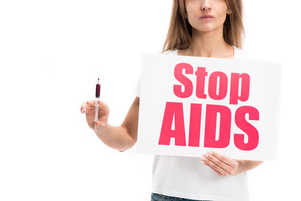 cropped image of woman holding card with stop aids text and syringe isolated on white, world aids day concept - Photo, Image
