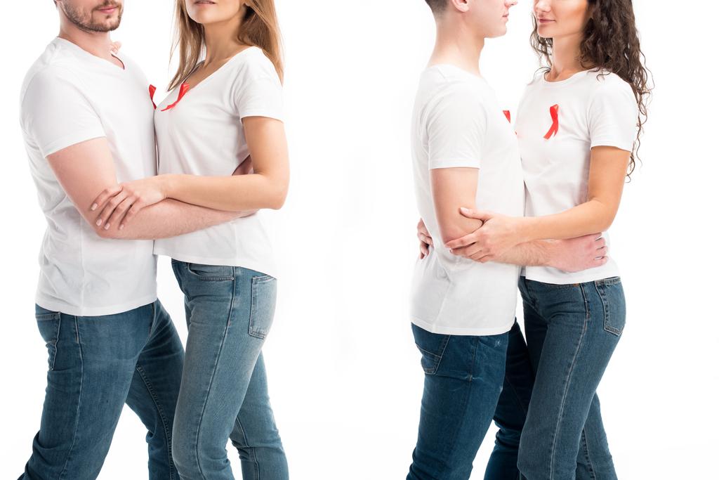cropped image of two heterosexual couples with red ribbons hugging isolated on white, world aids day concept - Photo, Image