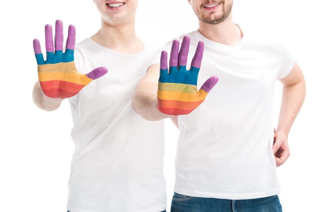 cropped image of smiling gay couple showing hands painted in colors of pride flag isolated on white, world aids day concept - Photo, Image